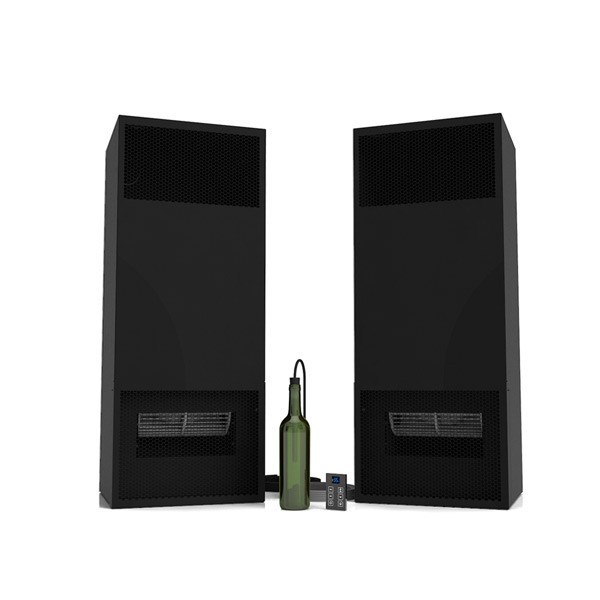 a bottle of wine sits next to a pair of speakers